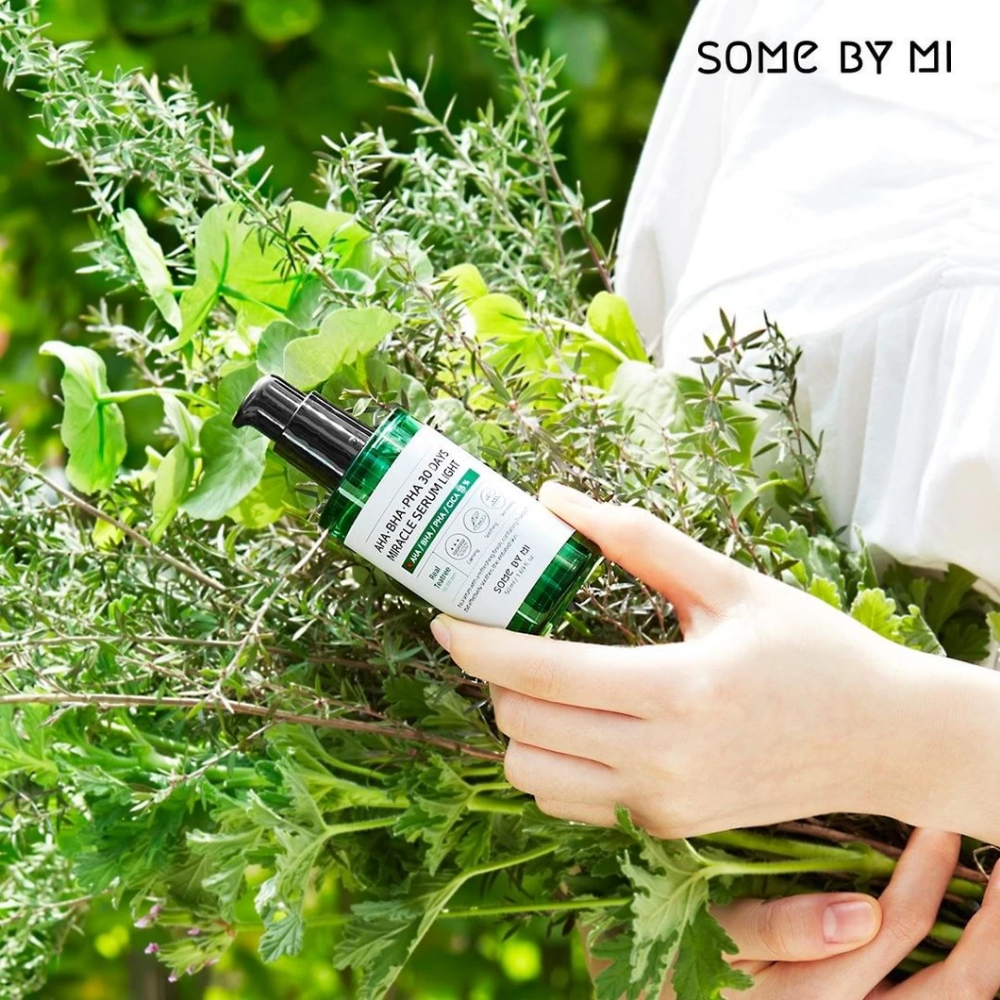 A woman holding a bunch of herbs in her hands to counteract pigmentation spots and acne using AHA, BHA, PHA 30 Days Miracle Serum Light 50ml from SOME BY MI.