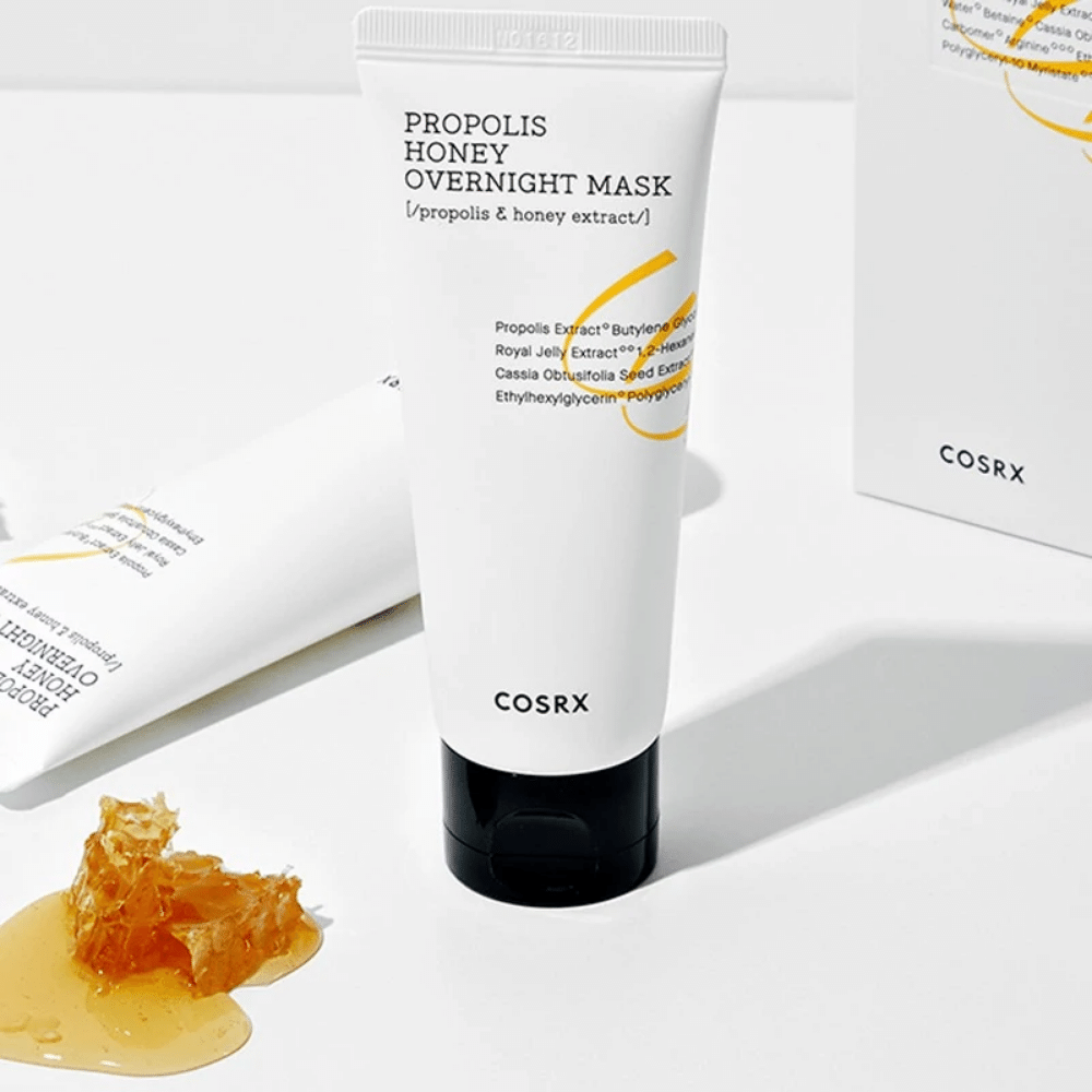 A box Full Fit Propolis Honey Overnight Mask 60ml from COSRX with a bottle of honey next to it, with propolis extract.